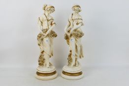 A pair of large figures depicting female