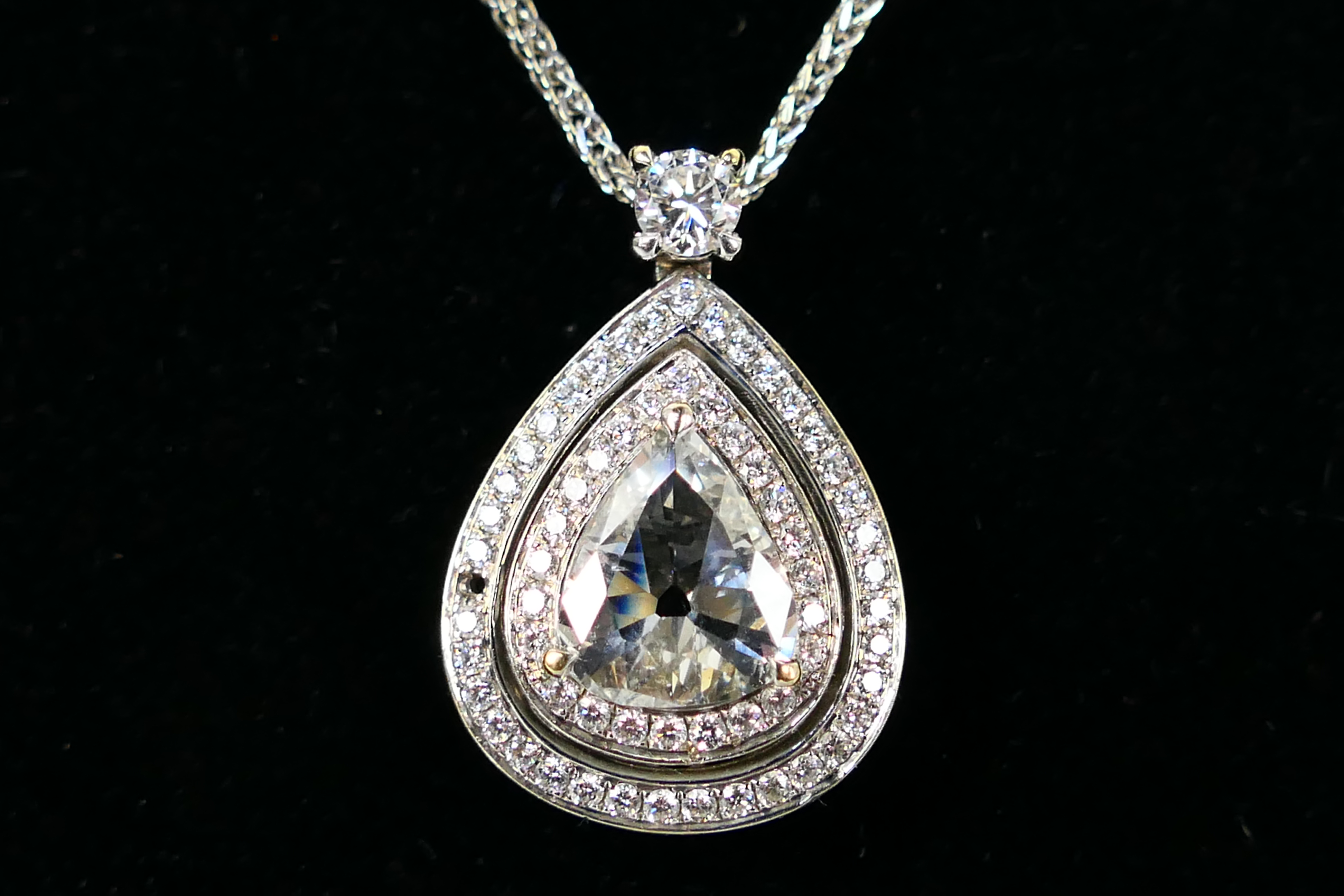 An 18ct white gold Diamond pendant conta