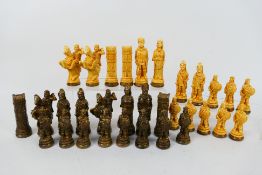 A set of viking themed chess pieces havi