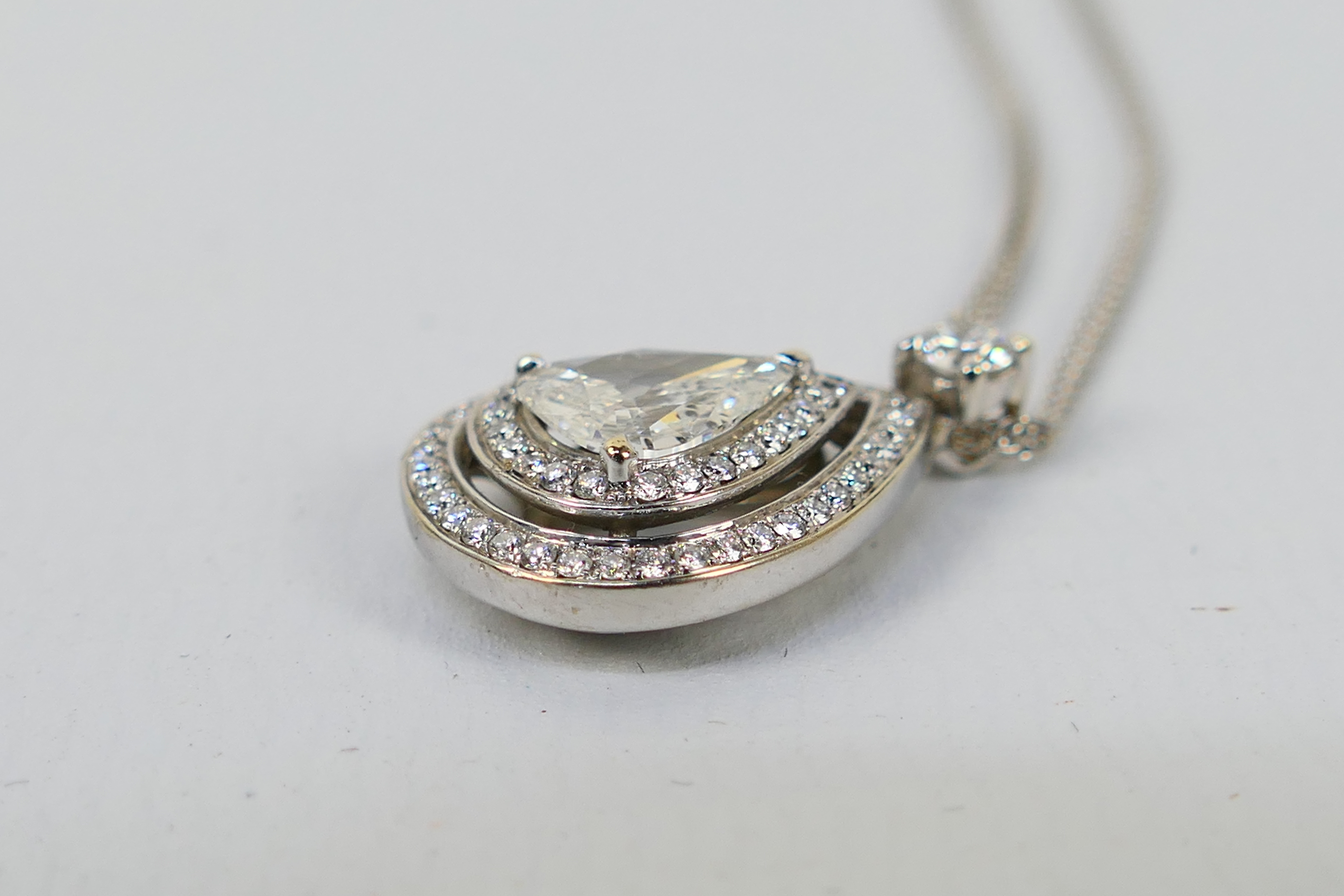 An 18ct white gold Diamond pendant conta - Image 11 of 11