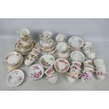 A collection of floral decorated tea wares comprising cups saucers and plates.