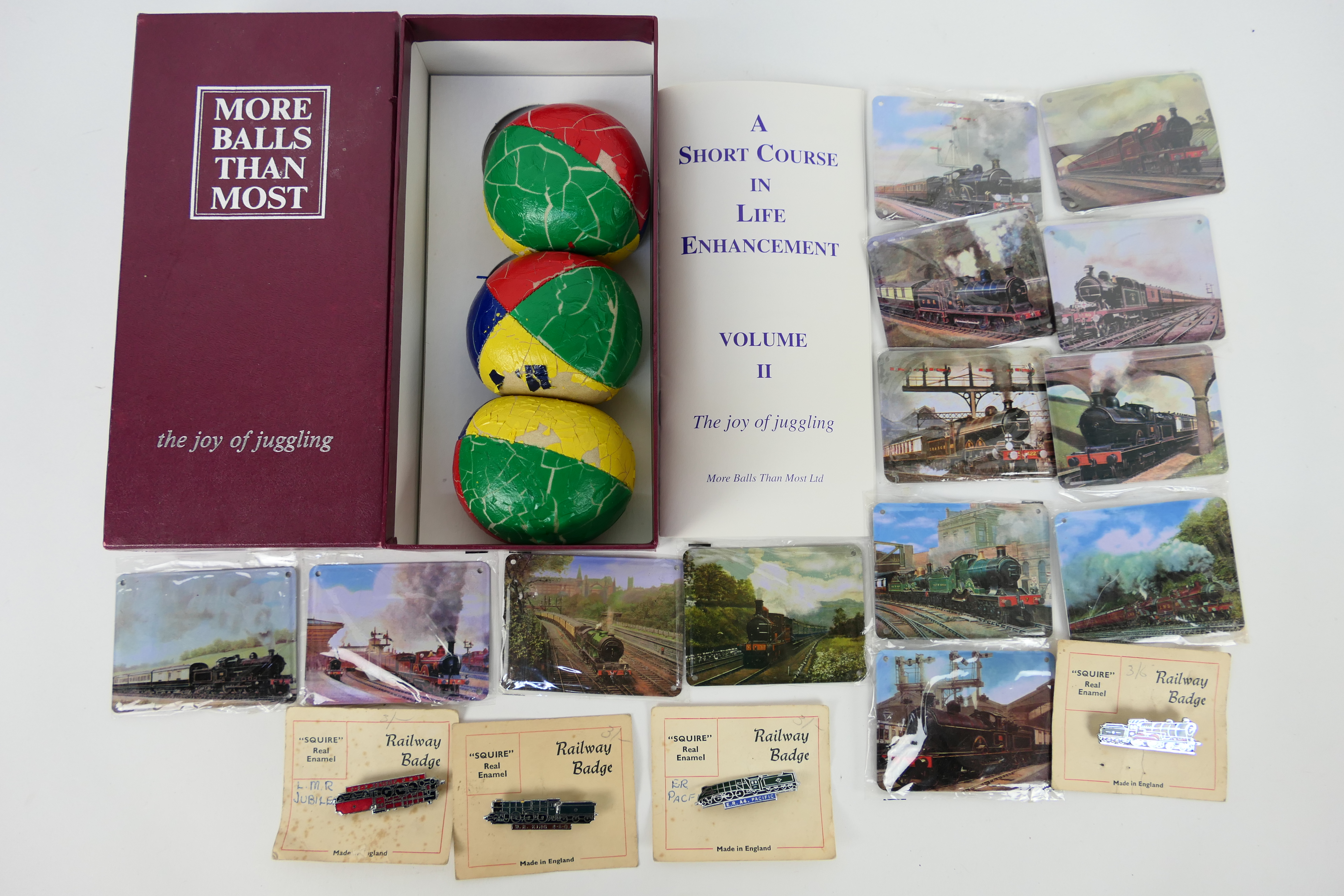 A vintage juggling set and a quantity of Atlas Editions train plaques.