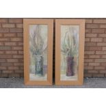 A set of two beech framed prints, each a floral still life, approximately 90 cm x 29 cm image size.