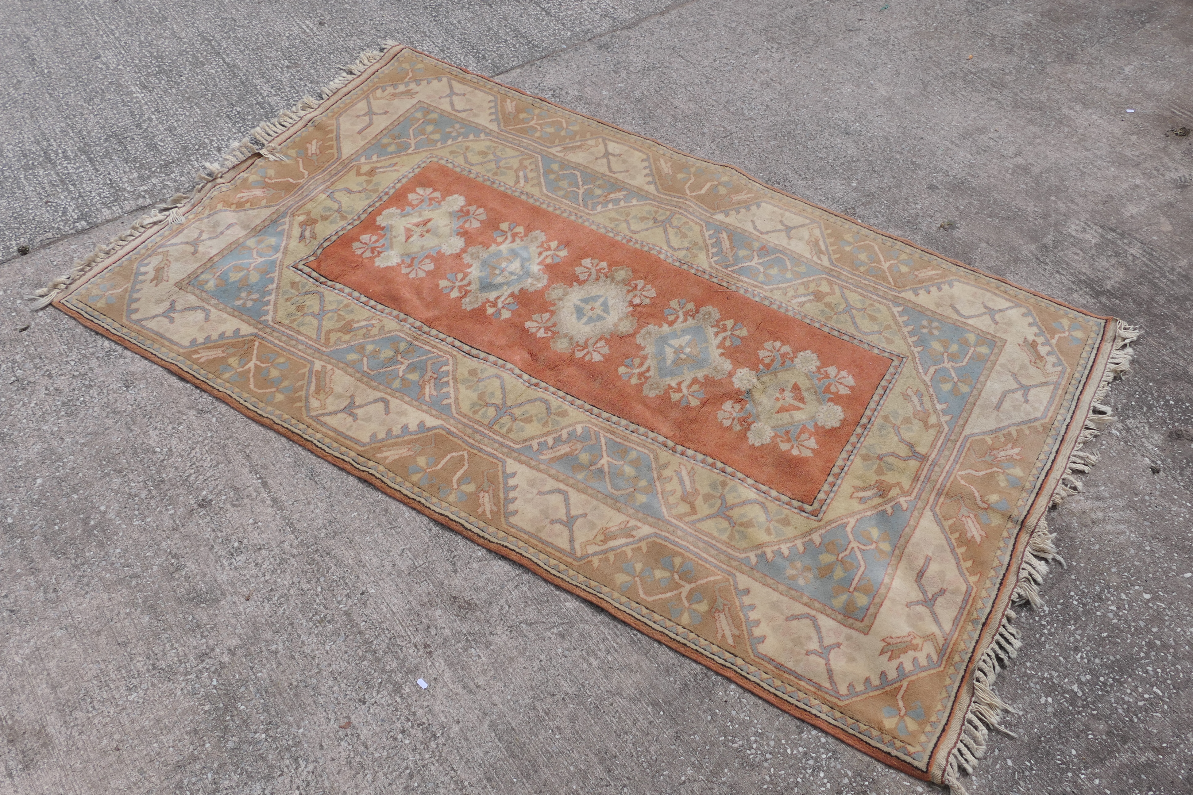 A carpet with geometric floral decoration, approximately 260 cm x 157 cm.