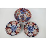 Three pieces of Imari ware comprising a bowl decorated with central basket of flowers,