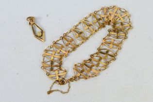 A 9ct yellow gold openwork bracelet, 19 cm (l) and a 9ct gold pendant, approximately 8.4 grams.