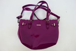 Debenhams - A pink glossy Debenhams handbag with shoulder strap - Bag has one inner zip pocket and