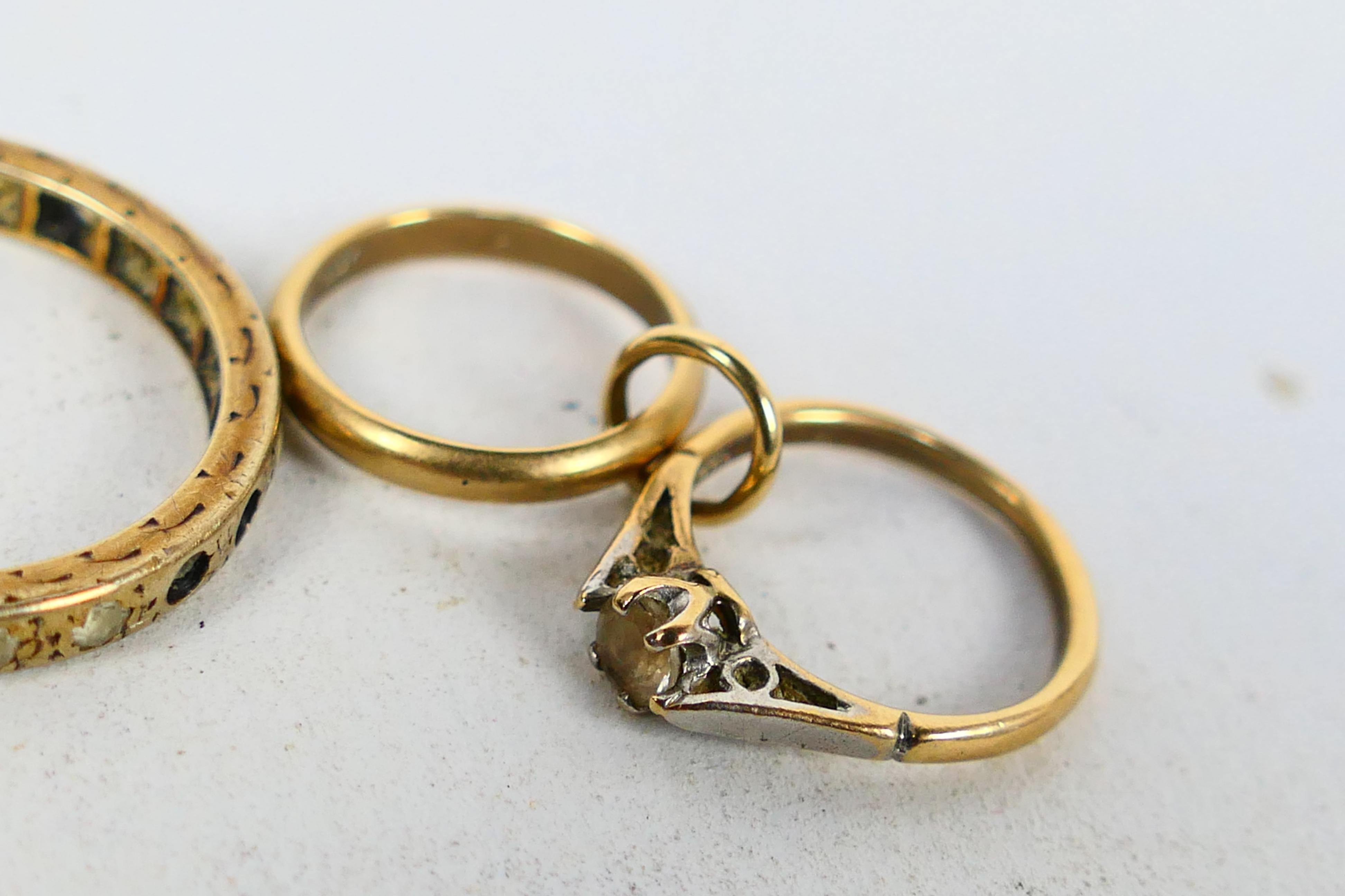 A 9ct gold charm in the form of an engagement and wedding ring and a yellow metal eternity ring - Image 3 of 4