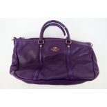 Coach New York - a Purple Coach handbag, labelled with makers mark, with shoulder strap,