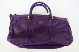 Coach New York - a Purple Coach handbag, labelled with makers mark, with shoulder strap,