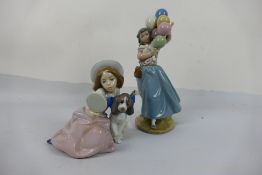 Lladro - Two figures / groups comprising Balloon Seller # 5141 and Who's The Fairest # 5468,