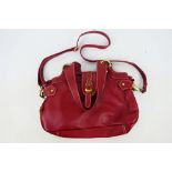 Catwalk Collection - A dark red leather handbag with shoulder strap - Handbag has two inside zip