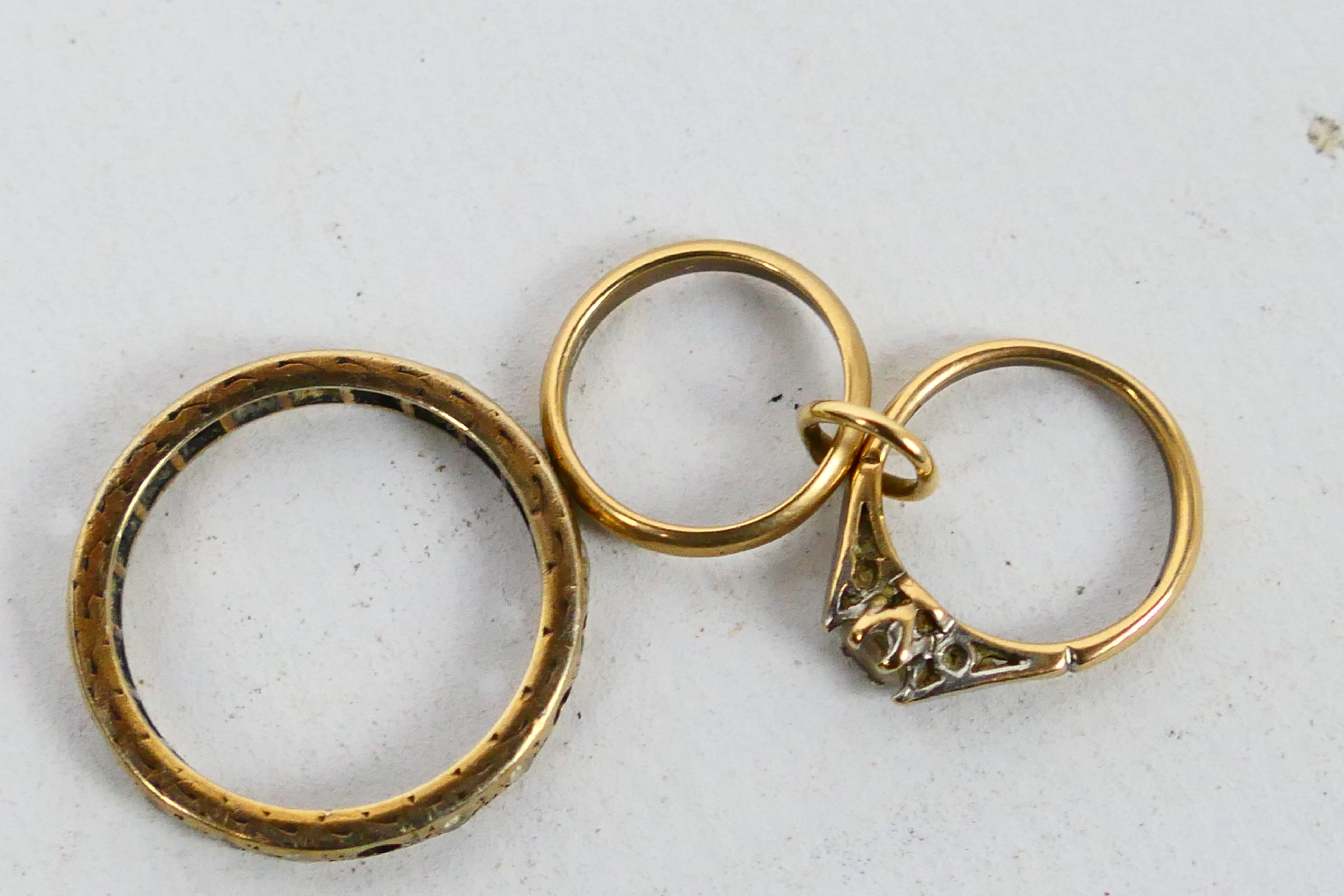 A 9ct gold charm in the form of an engagement and wedding ring and a yellow metal eternity ring - Image 4 of 4