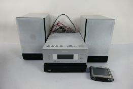 A Sony Micro Hi-Fi Component System CMT-BX7DAB with two speakers and a Tom Tom Sat Nav.