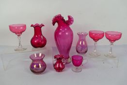 Cranberry Glass - a tall cranberry glass vase with frilled rim 29 cm (h) and eight further pieces