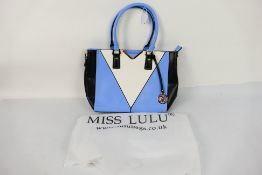 Miss Lulu - A white, black,