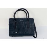 Radley - A dark blue Radley London leather handbag with shoulder strap - Handbag has one inner zip