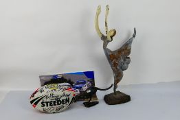 A metal sculpture depicting a stylised ballerina, 65 cm (h), a signed rugby ball and other.