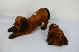 Two carved wood models of dogs, largest approximately 23 cm (h). [2].
