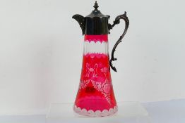 Cranberry Glass - a 19th century cut-to-clear tapered claret jug decorated in a floral and foliate