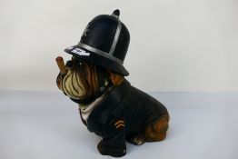 A model depicting an English Bulldog in police uniform smoking a cigar, approximately 39 cm (h).