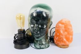 Lot to include a salt crystal lamp, glass head containing fairy lights for illumination and other.