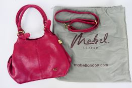 Mabel London - A Mabel London handbag in a shade of red. With two carry handles and shoulder strap.