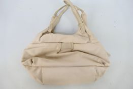 Radley - A white Radley London leather handbag - Handbag has two interior zip pockets,