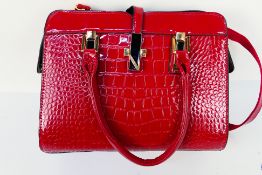 A red leather unknown maker hand/shoulder bag.