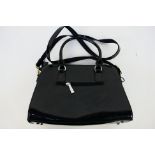 Superbia - A glossy black Superbia handbag with shoulder strap - Handbag has two inside zip pockets,