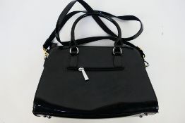 Superbia - A glossy black Superbia handbag with shoulder strap - Handbag has two inside zip pockets,