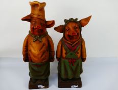 Two anthropomorphic models of pigs, largest approximately 63 cm (h). [2].