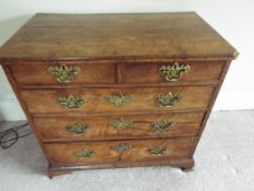 A Georgian chest of two over three drawers with fancy brass drop handles,