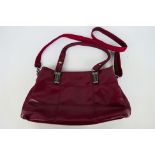 All Fancy - A burgundy All Fancy leather handbag with shoulder strap - Bag has two inner zip