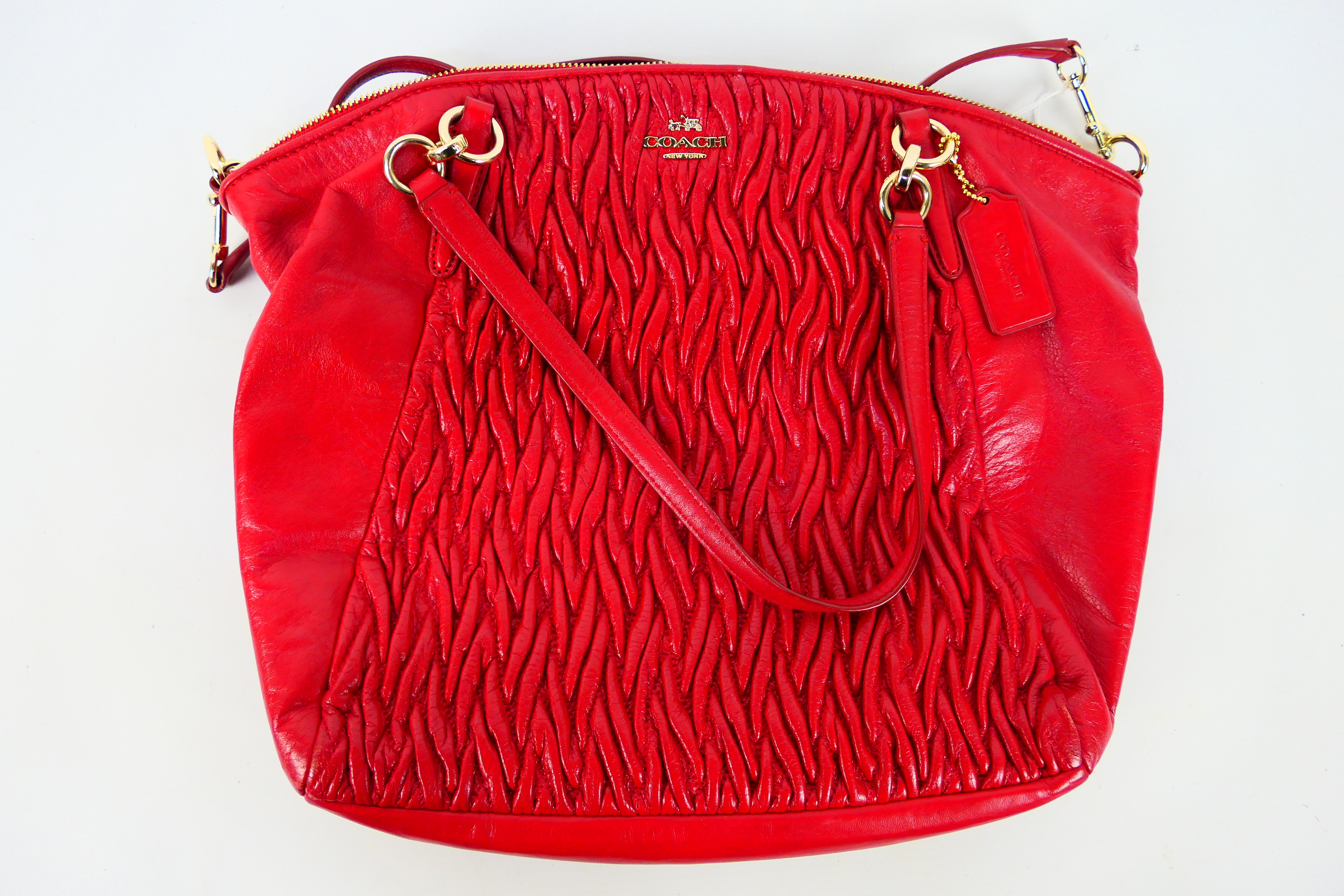 Coach New York - a Red Coach handbag, labelled with makers mark, with shoulder strap,