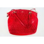 Coach New York - a Red Coach handbag, labelled with makers mark, with shoulder strap,
