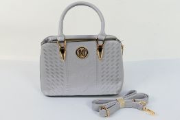 A grey handbag marked M with good quality stitched design and shoulder strap,