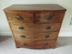 A Victorian bow fronted chest of two over three drawers with brass drop handles,