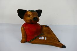 A carved wood anthropomorphic pig, 26 cm (h). [W].