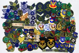 A collection of predominantly American military badges and patches.