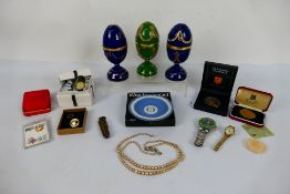 A mixed lot to include watches, commemorative coins, Bradford Exchange jewelled eggs and other.