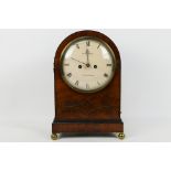 An early 19th century mahogany-cased arch top mantel clock,