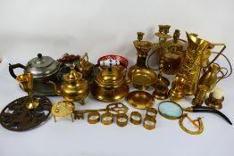 A collection of metalware comprising brass and pewter.