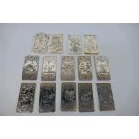 A collection of Chinese white metal trade tokens / plaques, predominantly with zodiac decoration,