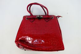 Nicole and Doris - A red Nicole and Doris handbag with shoulder strap - Bag has two inner zip