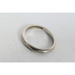 A white metal band ring, stamped AW PLATINUM 97%, size J+½, approximately 3.