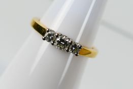 An 18ct yellow gold diamond trilogy ring, size N+½, stated diamond weight 0.