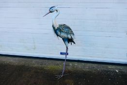 A decorative metal garden ornament in the form of a heron, 107 cm (h).