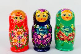 Russian Nesting Dolls - Three sets of five traditional style Matryoshka dolls,