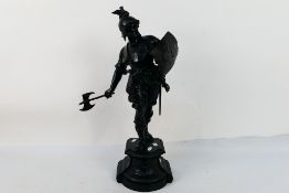 A late 19th or early 20th century spelter figure depicting a classical warrior with axe and shield,